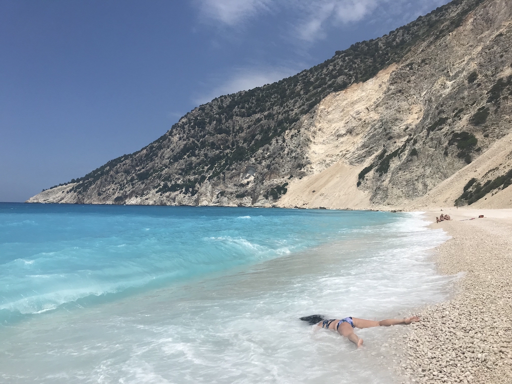 STEFDIES lying face-down after the wave recedes at Myrtos Beach